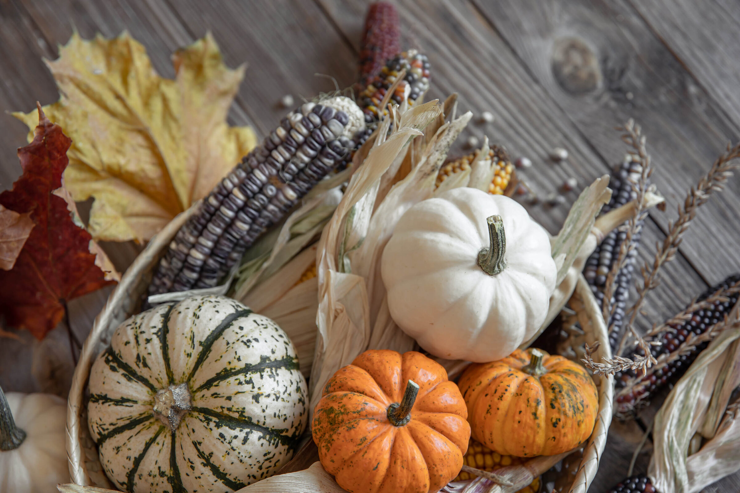 Autumn Composition With Pumpkins, Corn And Leaves On A Wooden Background.